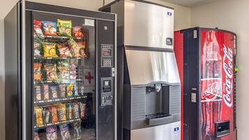 A vending machine with snacks and a Coca-Cola dispenser.