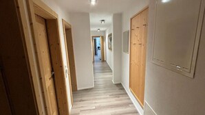 A hallway with wooden doors and a light-colored floor. - Fantastic Apartment in the Kitzbuhel Alps (Mittersill)