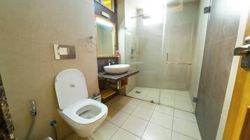 A bathroom with a toilet, sink, and shower.
