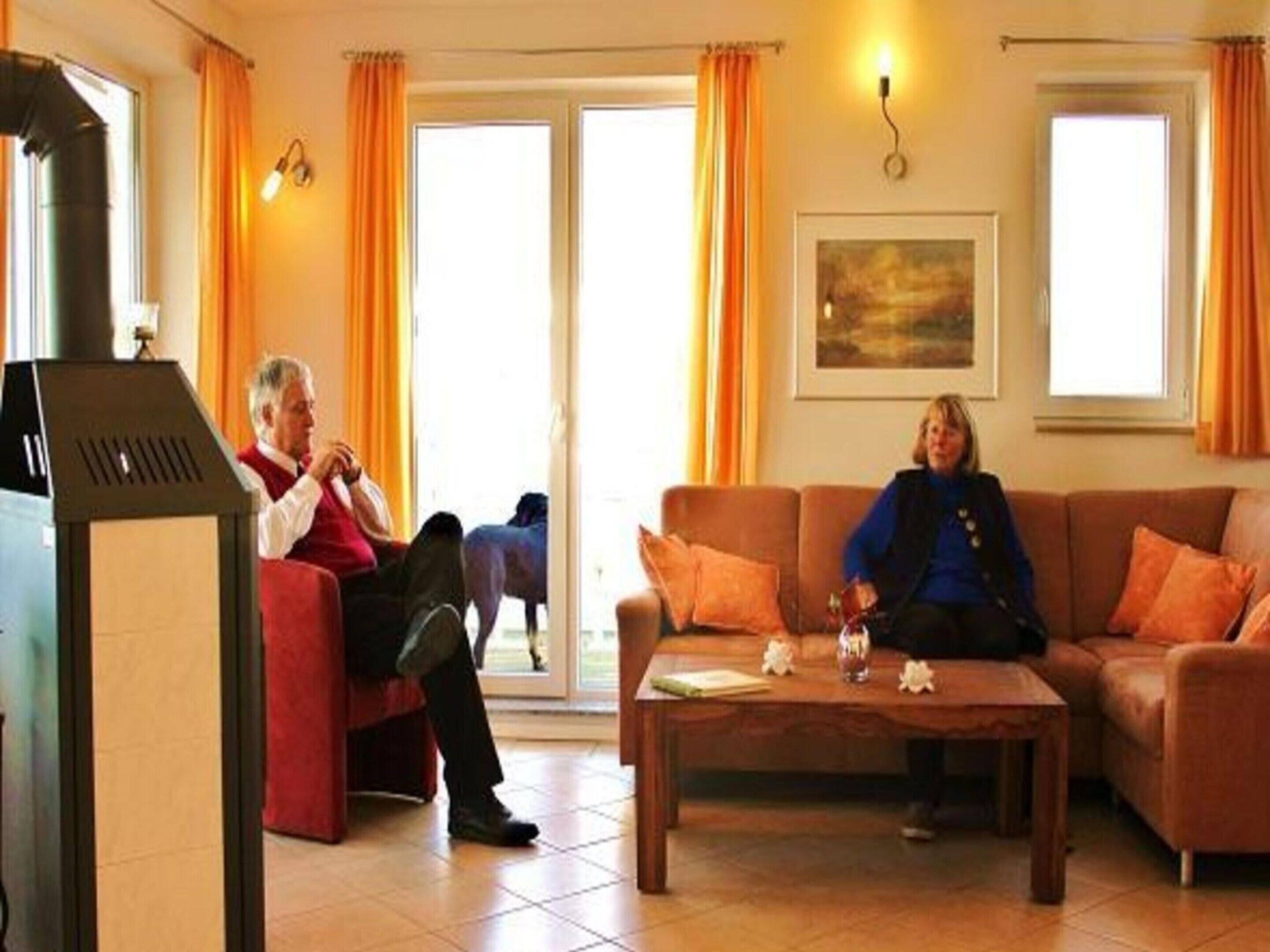 A living room with a fireplace, a sofa, a coffee table, and a painting on the wall.