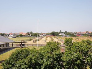A vineyard with rows of grapevines, a wooden fence, and a clear sky. - 6 Person Holiday Home on a Holiday Park (Karrebæksminde)