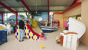 An indoor play area with a slide, play structures, and a beach-themed decoration. - Seepark Burhave, Burhave (Butjadingen)