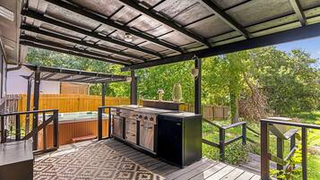 Enjoy al fresco dining with a grill station and outdoor seating area.