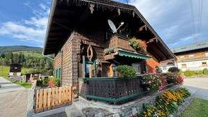 A traditional wooden chalet with a sloped roof, a balcony with flower boxes, and a stone foundation. - Chalet Near Passthurn Ski Area Kitzbuhel (Mittersill)