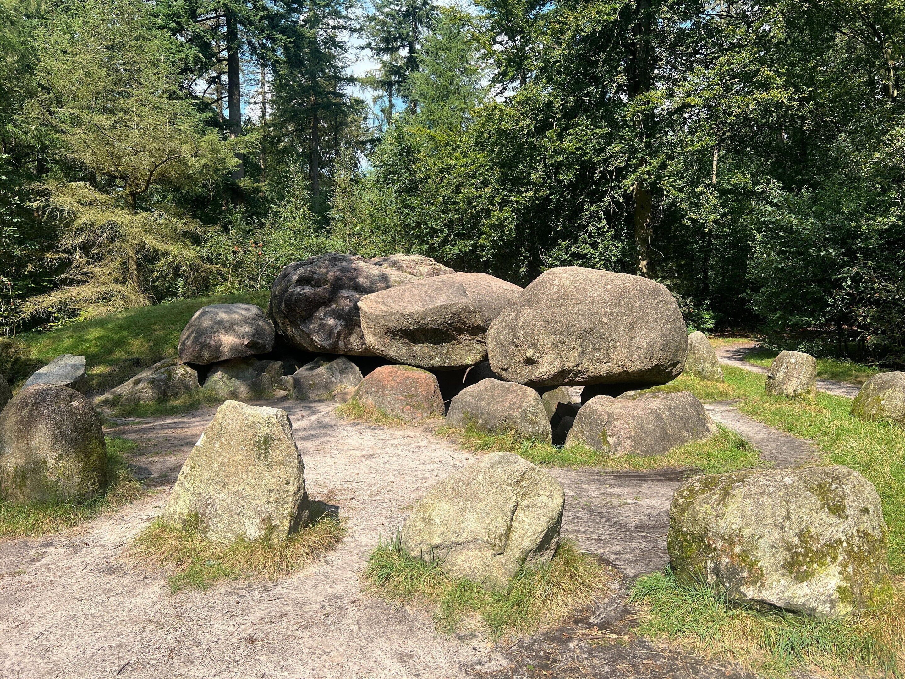 A natural outdoor setting with large rocks and a dirt path.