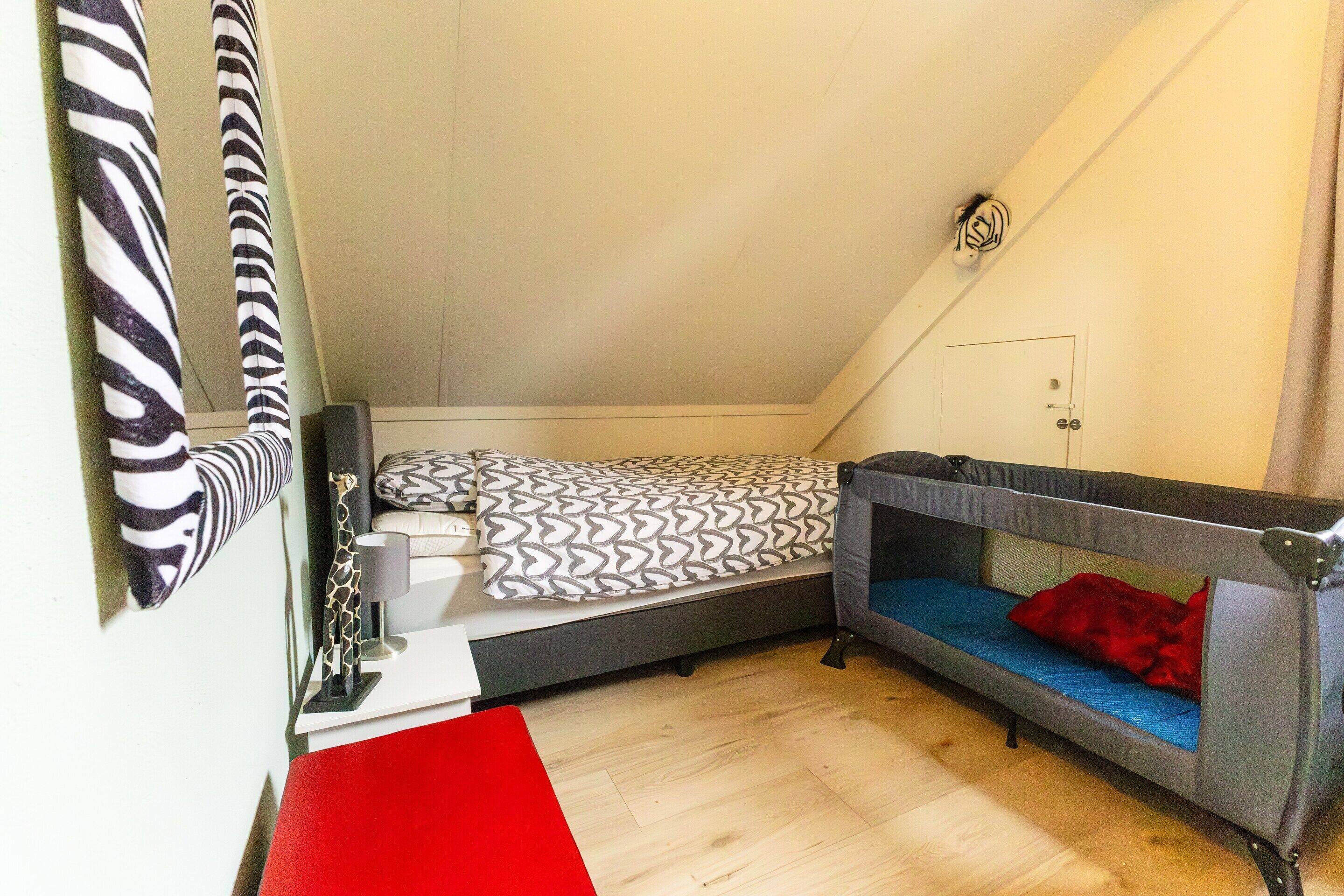 A small, compact room with a bunk bed, a desk, and a chair.