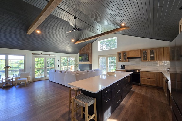 - Spacious open living and kitchen layout for groups - Large windows fill the home with natural daylight - A warm inviting hub perfect for cooking and lounging