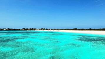 Beach nearby, white sand, beach umbrellas, beach towels