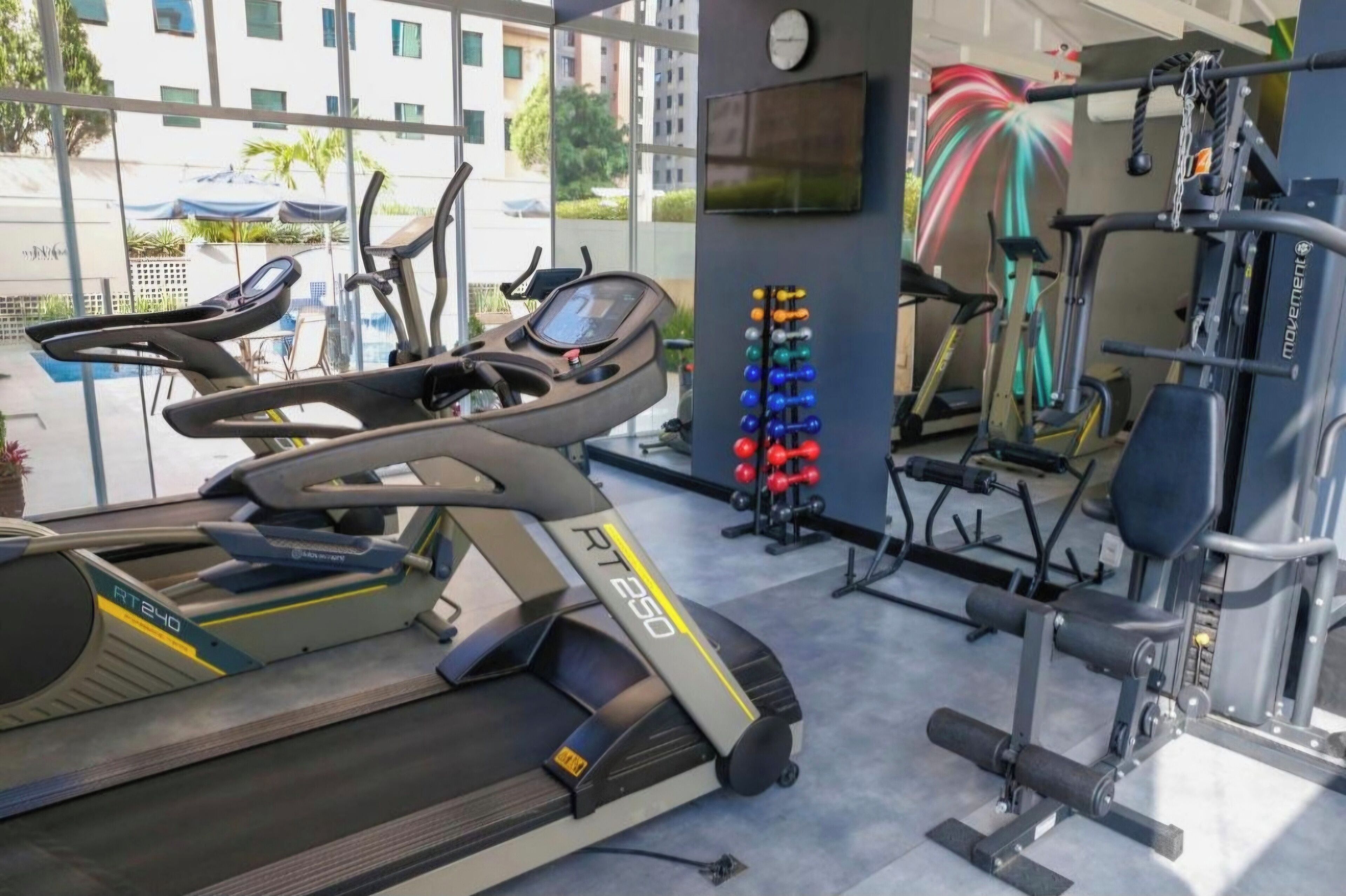A gym with treadmills, stationary bikes, and weight machines.