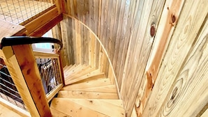 A wooden spiral staircase with a metal railing, leading to a balcony with a mountain view. - Up-cycled Grain Bin Villa just 20 mins. from the Great Sand Dunes NP w/ WiFi, AC (Mosca)