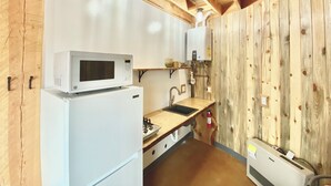 A compact kitchen with a microwave, stove, sink, and a water heater. - Up-cycled Grain Bin Villa just 20 mins. from the Great Sand Dunes NP w/ WiFi, AC (Mosca)