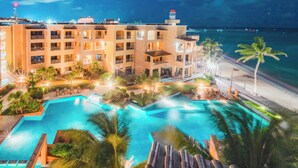 Un hôtel doté de nombreux balcons, d’une piscine et offrant une vue sur la plage.