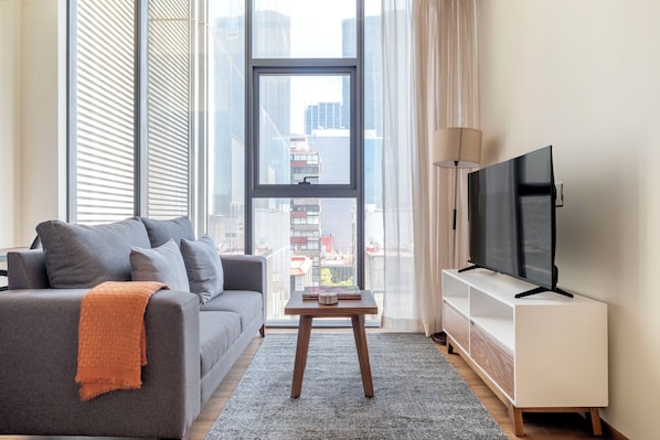 Comfort Apartment | Living area | 40-inch Smart TV with digital channels