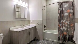 A modern bathroom with a shower, toilet, and vanity. - 210 Brand New 1 Bedroom, 1 Bath, 1 Full Kit, 1 Liv (Dunellen)