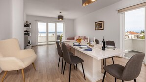 Un apartamento moderno con comedor, sofá y vista a la ciudad.