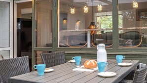 A dining table with chairs, a white pitcher, and blue cups. - 2 bedroom amazing home in Kalundborg (Kalundborg)