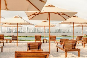 On the beach, sun-loungers