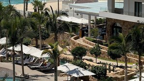 A beachfront hotel with multiple balconies, a pool area, and a view of the ocean. - Luxurious Beachfront Resort Villa La Valencia Studio unit. Great views & dining. (San José del Cabo)