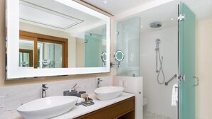 A modern bathroom with two sinks, a large mirror, and a glass-enclosed shower. - Luxurious Beachfront Resort Villa La Valencia Studio unit. Great views & dining. (San José del Cabo)