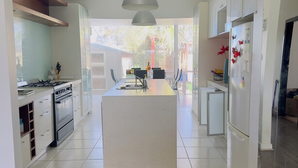 A modern kitchen with a central island, stainless steel appliances, and a large pendant light. - 3 Bedroom cozy villa in Werribee near  Werribee CBD and other amenities (Werribee)