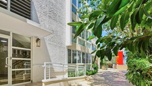 A modern building with a textured facade, large windows, and a gated entrance. - Villa Georgetti Hidden Gem in Miramar, SJ | Power Generator, Water Cistern, Parking (San Juan)