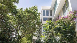 A modern building with large windows and a balcony. - Villa Georgetti Hidden Gem in Miramar, SJ | Power Generator, Water Cistern, Parking (San Juan)