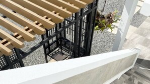 A staircase with grey stone steps and a wooden pergola structure above.