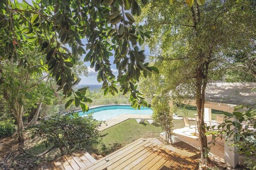 Stunning 1950's grand house nestled in lush greenery overlooking the bay