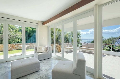 Stunning 1950's grand house nestled in lush greenery overlooking the bay
