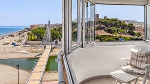 A balcony with a view of the beach, a chair, and a table. - Capitan by Interhome (Fuengirola)
