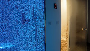 A bathroom with a mosaic tile wall, a shower, and a digital display. - Villa Agave - Superior Spa Room (Gaggi)