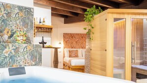 A spa room with a hot tub, wooden ceiling, and a bed with a wooden headboard. - Villa Agave - Superior Spa Room (Gaggi)