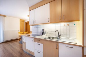 Fridge, stovetop, dishwasher, coffee/tea maker