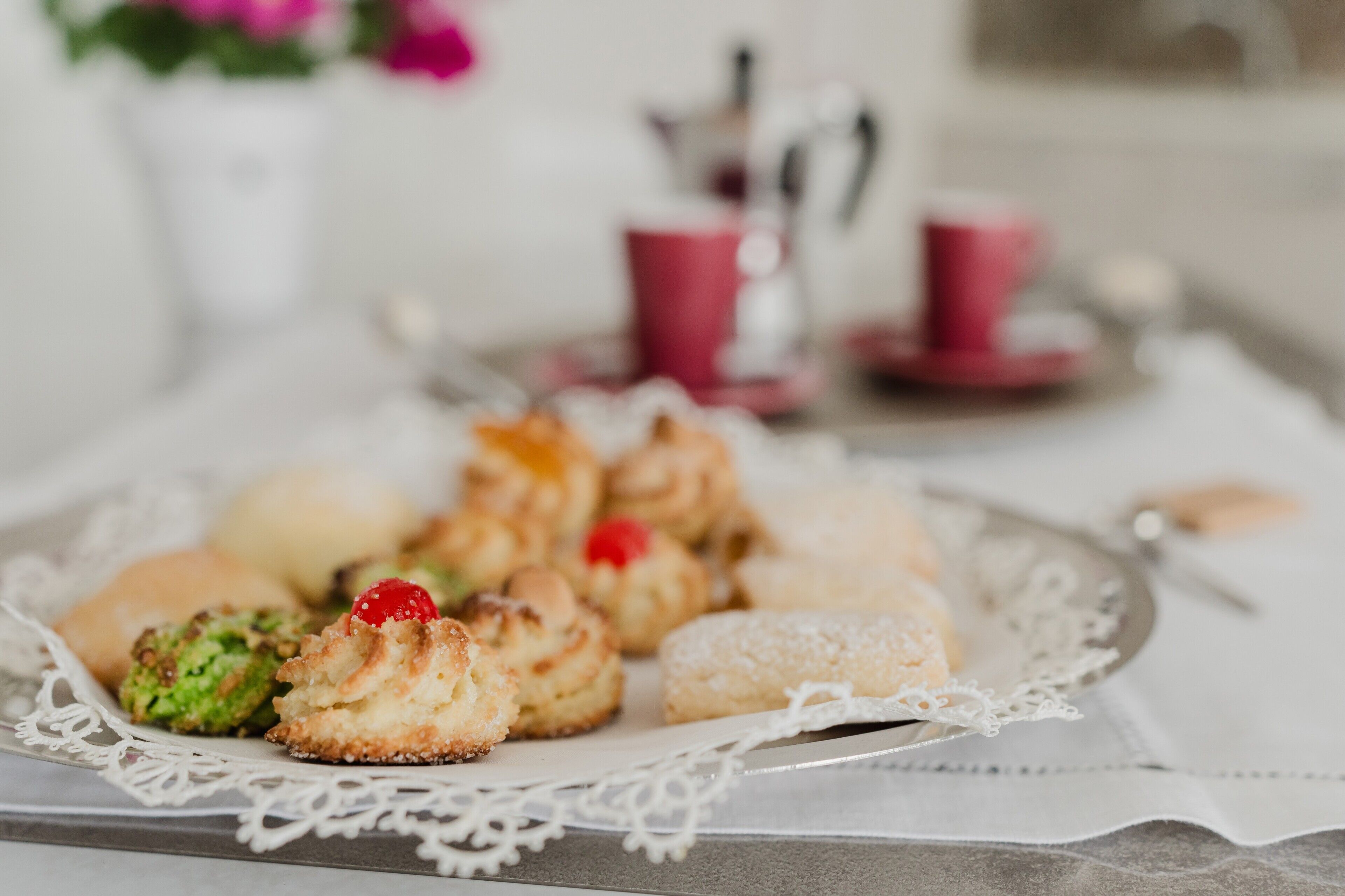 A plate of assorted pastries on a lace doily.