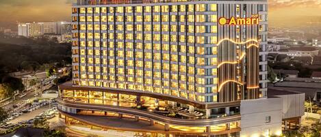 A multi-story hotel with a modern design, featuring a prominent 'Amari' sign on the facade.