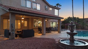 A house with a covered patio, outdoor seating, a pool, and a fountain. - Hummingbird Hideaway House with Private Pool in North Scottsdale (Scottsdale)