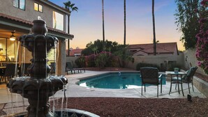 A backyard with a swimming pool, a fountain, outdoor furniture, and a patio area. - Hummingbird Hideaway House with Private Pool in North Scottsdale (Scottsdale)