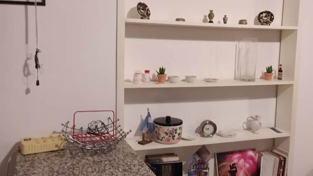 A kitchen with white shelves, a kettle, a teapot, and various kitchen items. - LOCRI Epizephiri - Apartment 3 pl - Very close to the sea  (Locri)