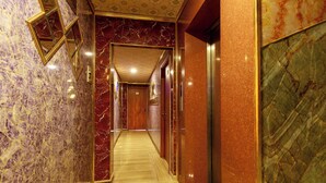 A marble-lined hallway with a wooden floor, a door with a number, and an elevator. - Venus Hotel & Massage - Bui Vien Walking (Ho Chi Minh City)
