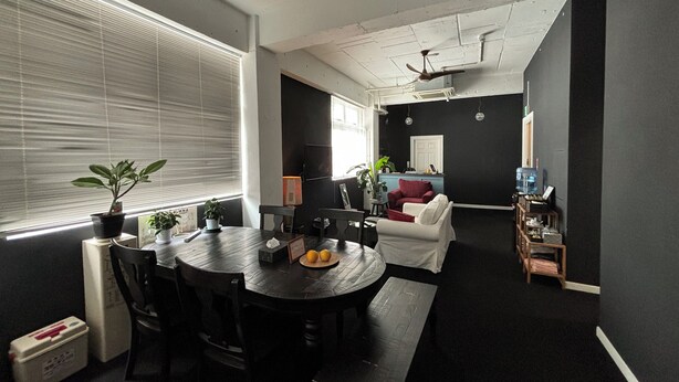 A modern living space with a dining area, a sofa, and a ceiling fan. - LANAI HOTEL AND Dormitory (Naha)