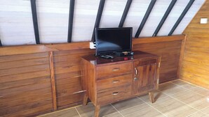A wooden cabinet with drawers and a television on top. - Cool Breeze 2 (Penida Island)