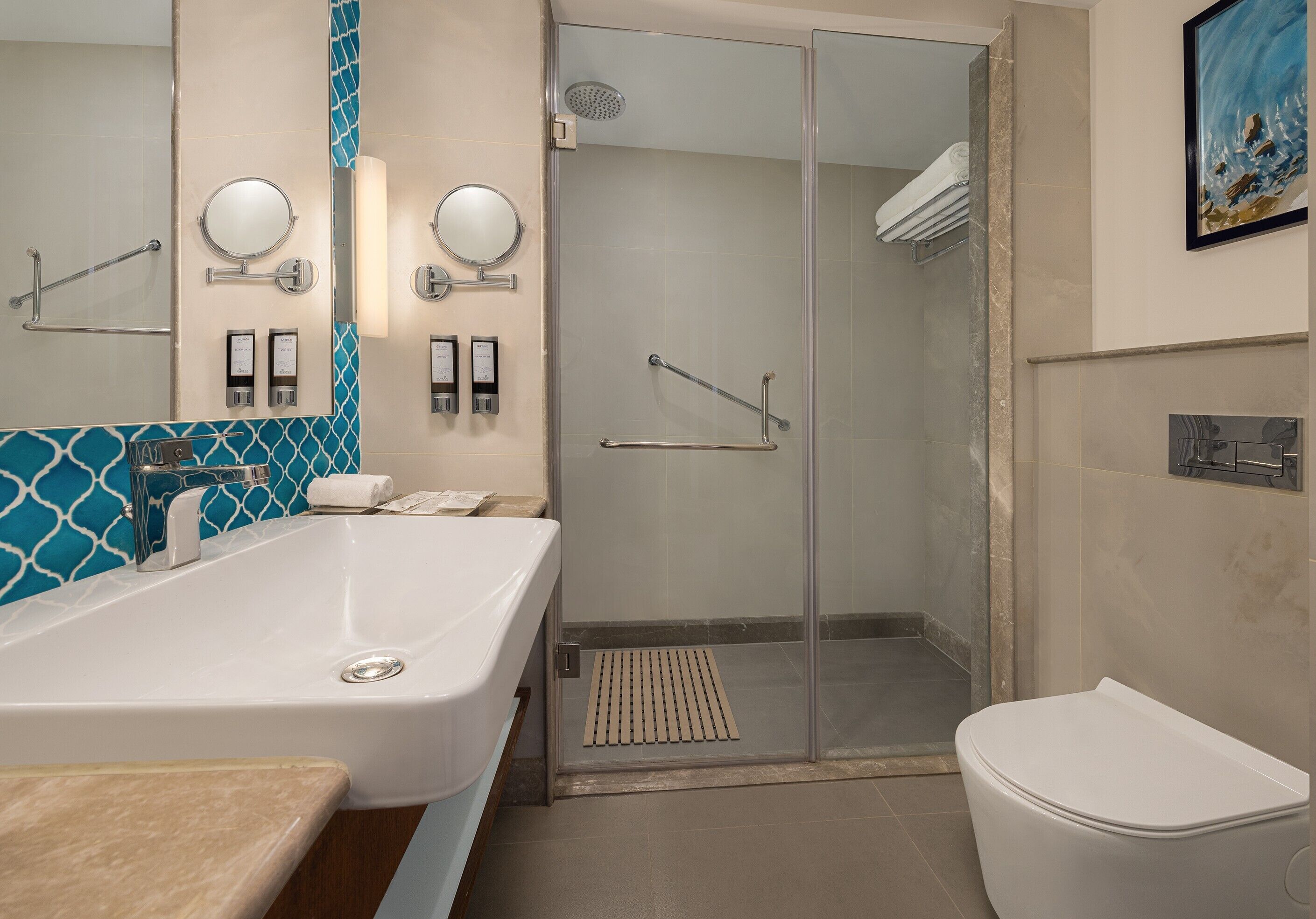 A modern bathroom with a large bathtub, a glass-enclosed shower, and a toilet.
