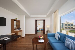 Suite, 1 King Bed | Living area | 53-inch LED TV with satellite channels, fireplace