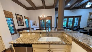 A kitchen with granite countertops, a stainless steel dishwasher, and beige cabinetry. -  Beautiful 4BR/4BA.Close to HHI/SAV/BEU, 5 minutes to Palmetto Bluff's entrance  (Bluffton)