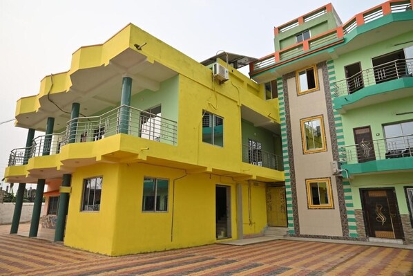 A multi-story residential building with balconies and a flat roof. - Manas Kanya Beach Resort (Kanthi)