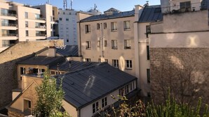 A residential area with multiple apartment buildings, some with solar panels on the roofs.