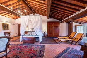 Experience a cozy retreat with a comfortable bed, ample storage, and a charming seating area.