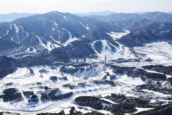 A mountainous landscape with snow-covered terrain and winding roads. - Holiday Inn Resort ALPENSIA PYEONGCHANG by IHG (Pyeongchang-gun)