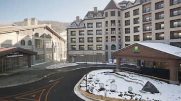 A hotel with a central courtyard, a convention center, and a snow-covered landscape.