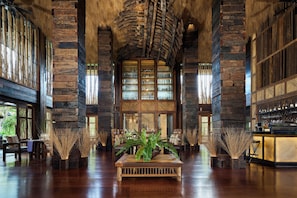 A spacious lobby with a central wooden table, large windows, and a bar area. - Dinso Resort & Villas Ko Chang, Vignette Collection by IHG (Ko Chang)